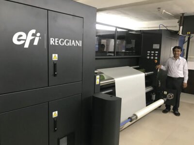 Budhabhai Sonani posing alongside EFI Reggiani VOGUE